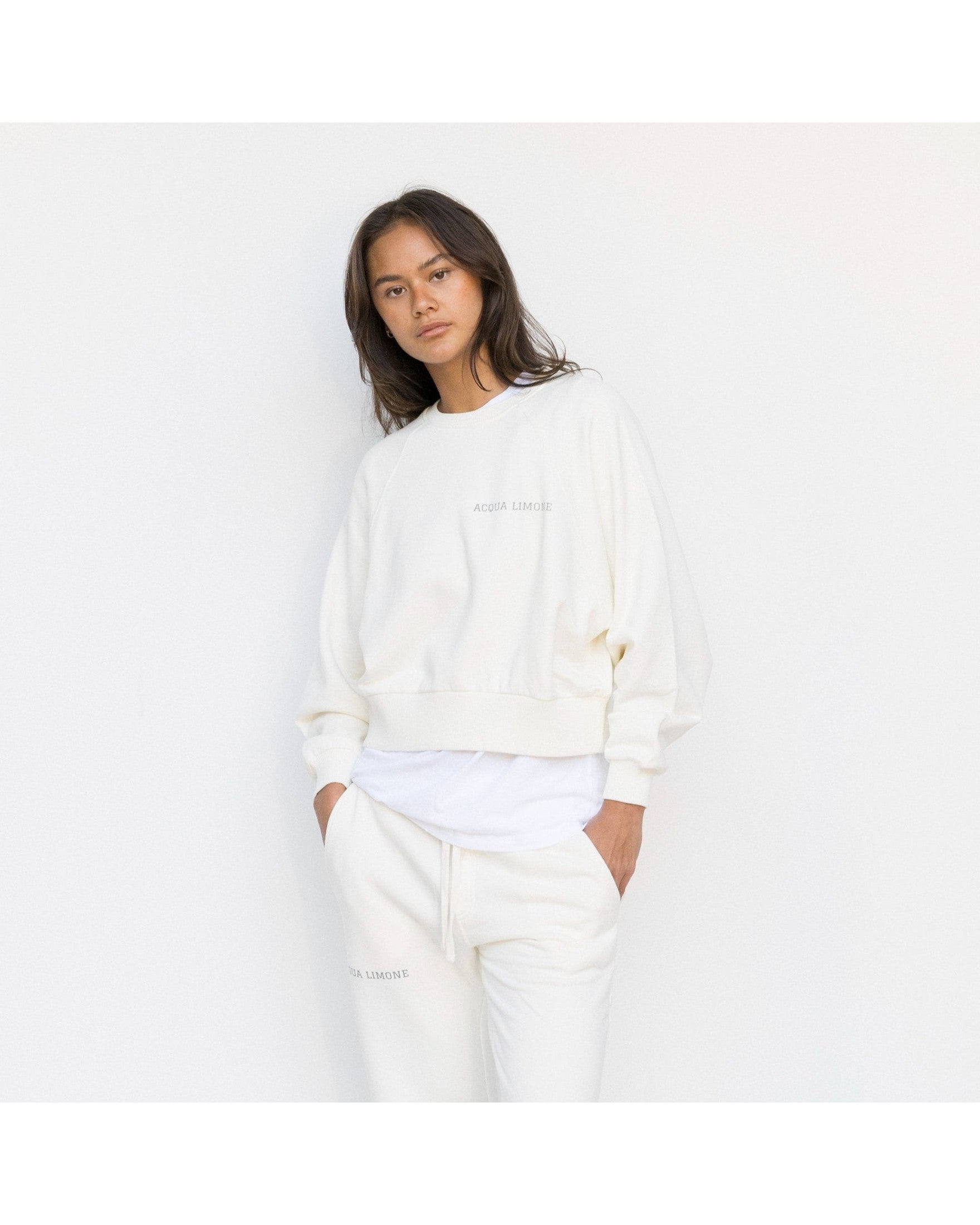 Person wearing a white outfit on a plain background