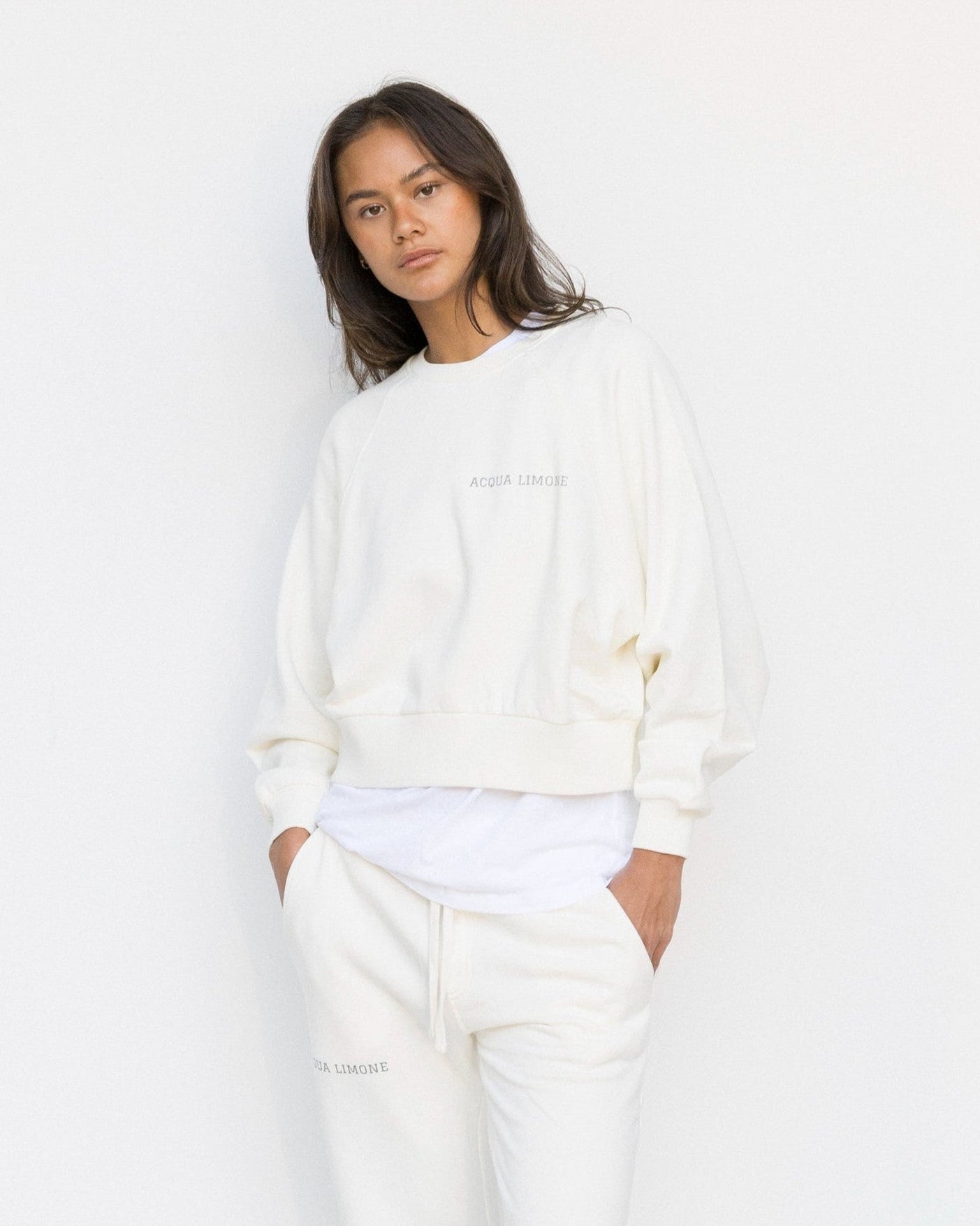 Person wearing a white outfit on a plain background