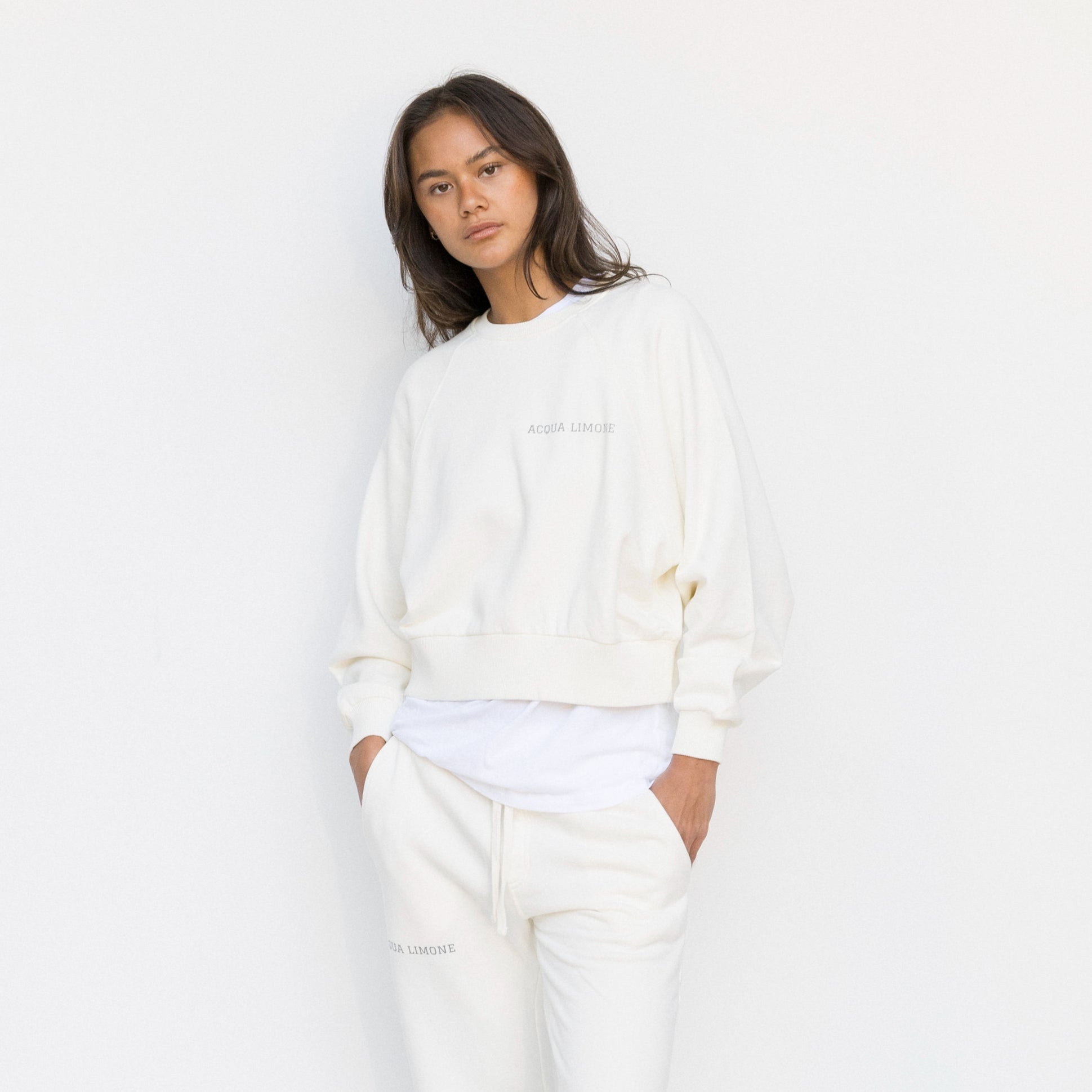 Person wearing a white outfit on a plain background